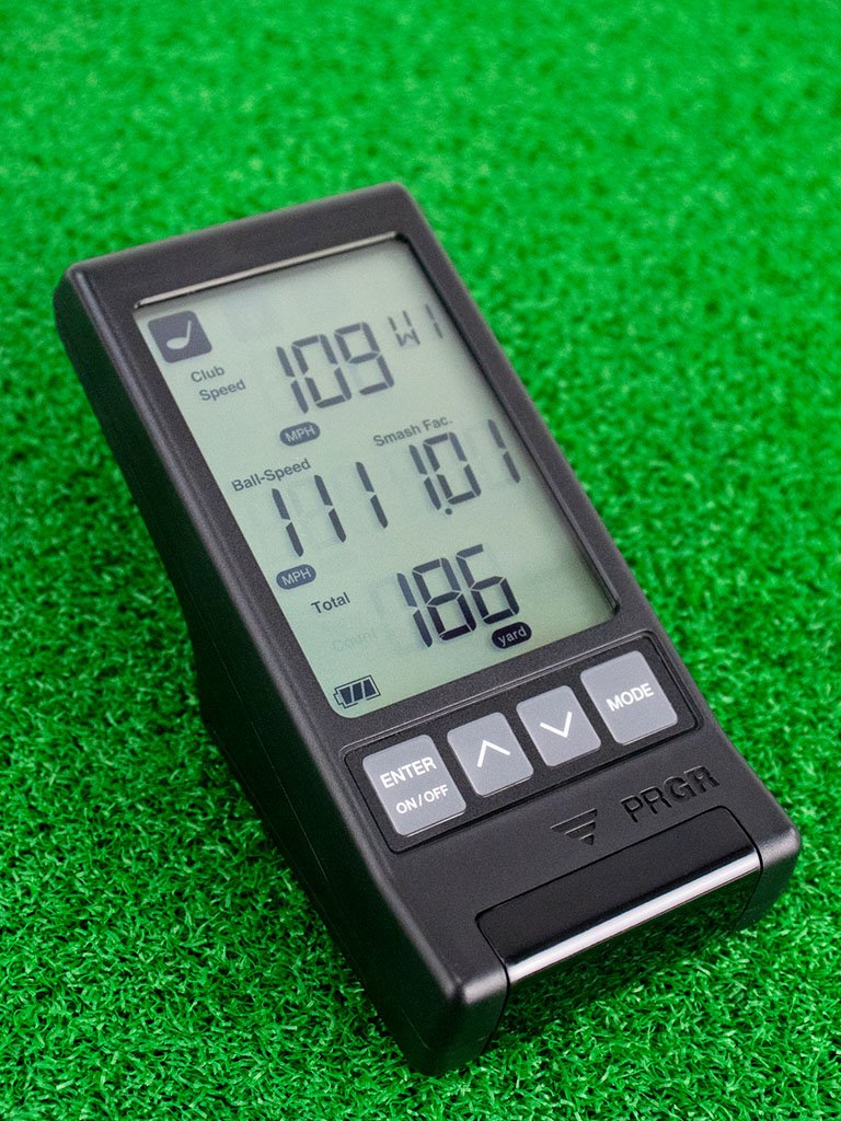 The PRGR Portable launch monitor on the green showcasing its digital screen