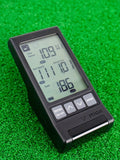 The PRGR Portable launch monitor on the green showcasing its digital screen