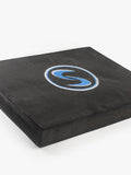 An angled shot of a black stability pro mat with a blue logo, designed for use in kneeling swings and stability training.