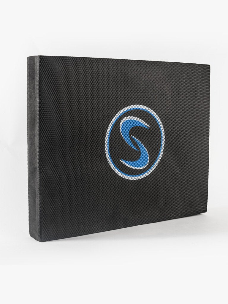 A black stability pro mat with a blue logo, designed for use in kneeling swings and stability training.