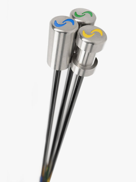 A set of three SuperSpeed golf training clubs, each with a different color grip: yellow, green, and blue, aligned vertically.